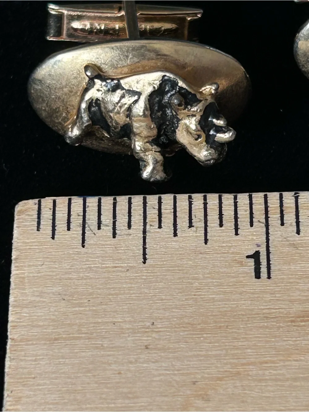 Rhinoceros gold tone cufflinks embossed with Armstrong Tires on the underneath.